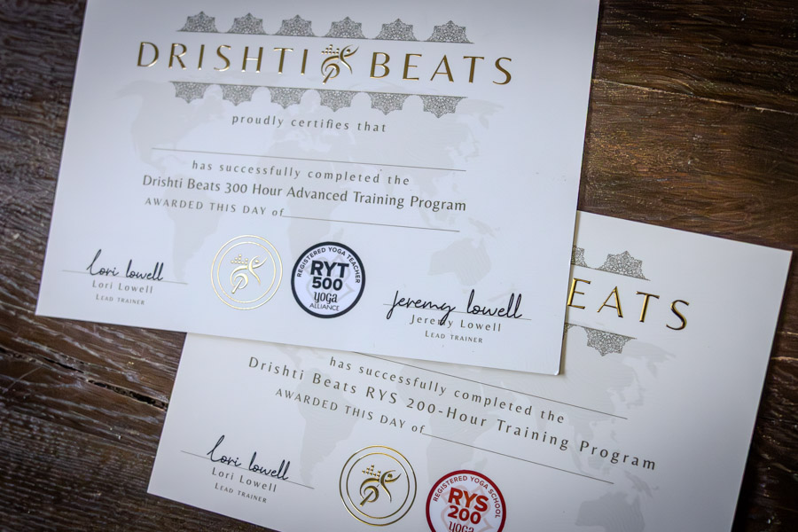Drishti Beats 200-Hour and 300-Hour Yoga Teacher Training certificates together, gold foil, wax-sealed, signed by Lori and Jeremy Lowell